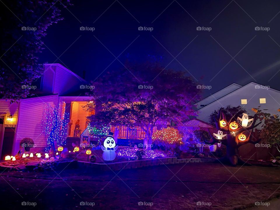 House decorated with purple and orange lights 