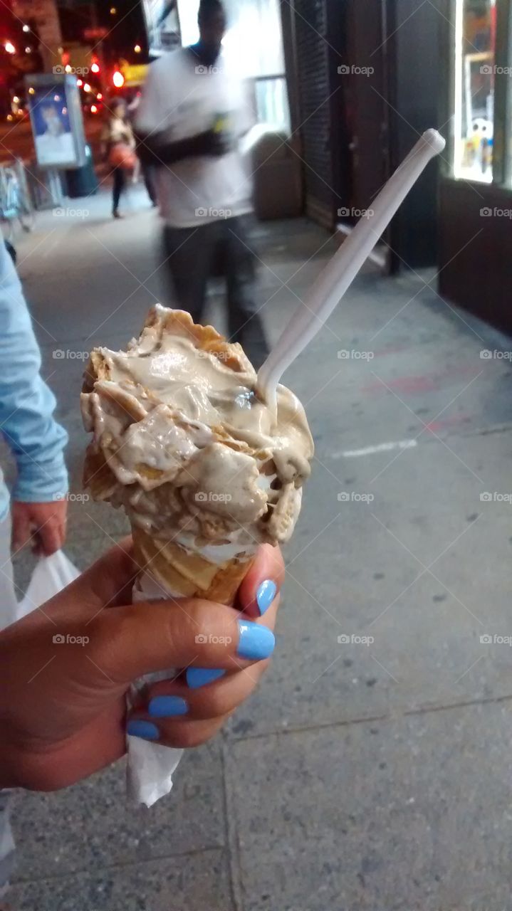 Girl holding Ice cream cone. on street NYC