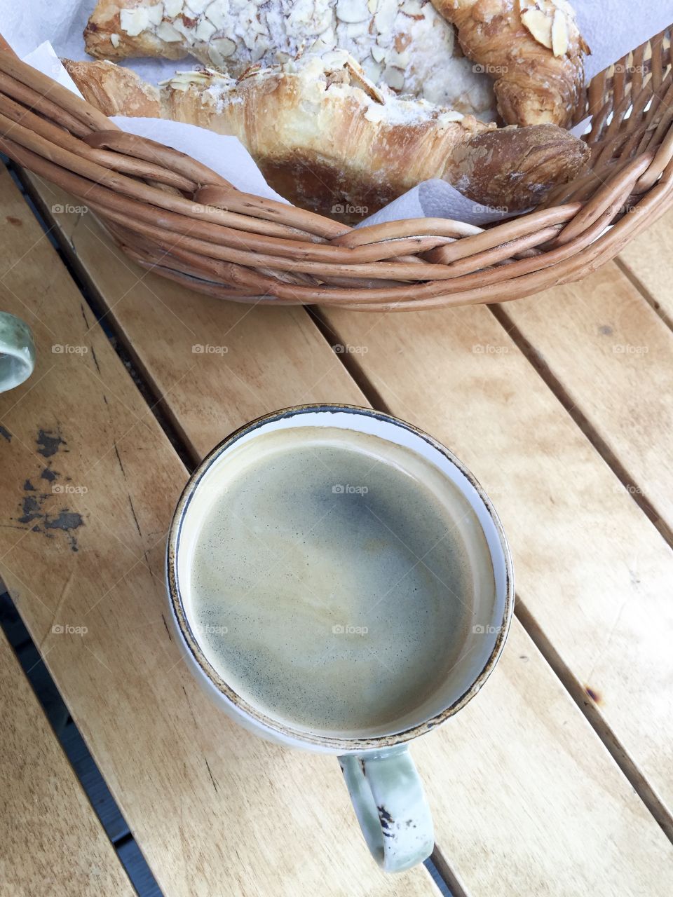 A cup of coffee and croissants.