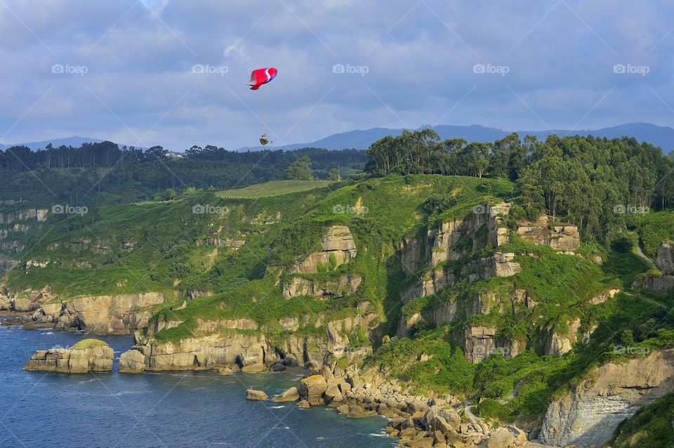 Paragliding over the green cliffs in Asturias.