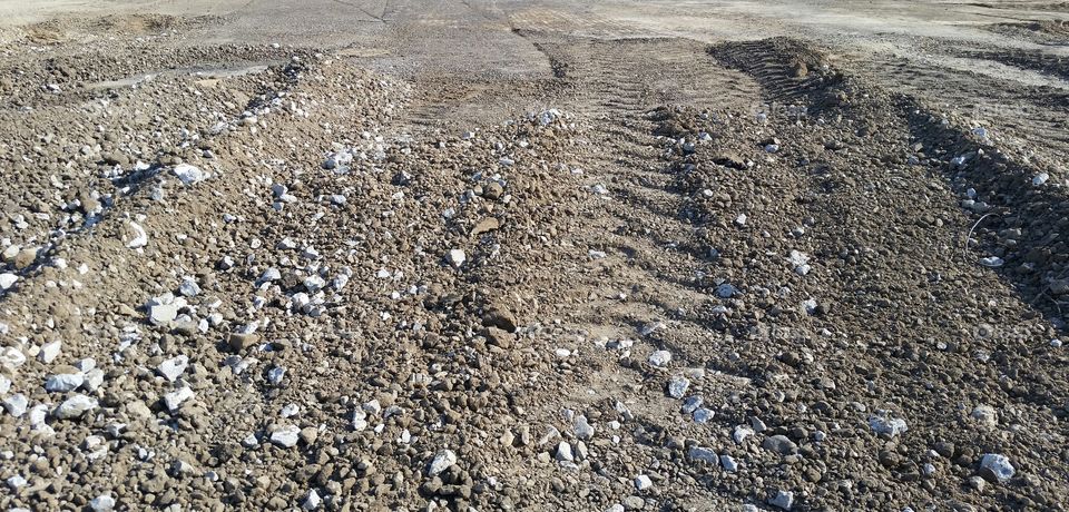 tire tracks on dirt and rock