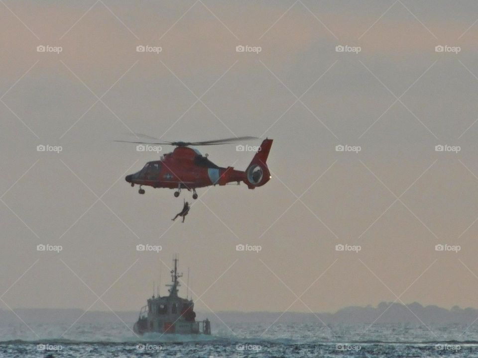 Life in Motion - A U.S. Coast Guard helicopter performs an Air-sea rescue of a capsizing fishing vessel