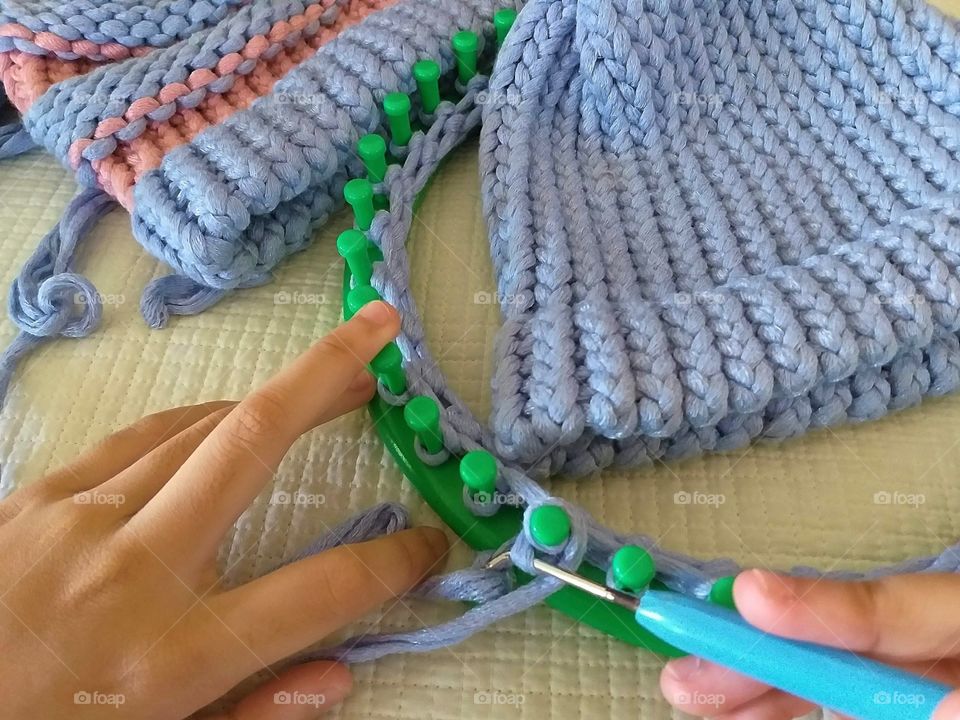 kitting by using knitting loom. hobby.