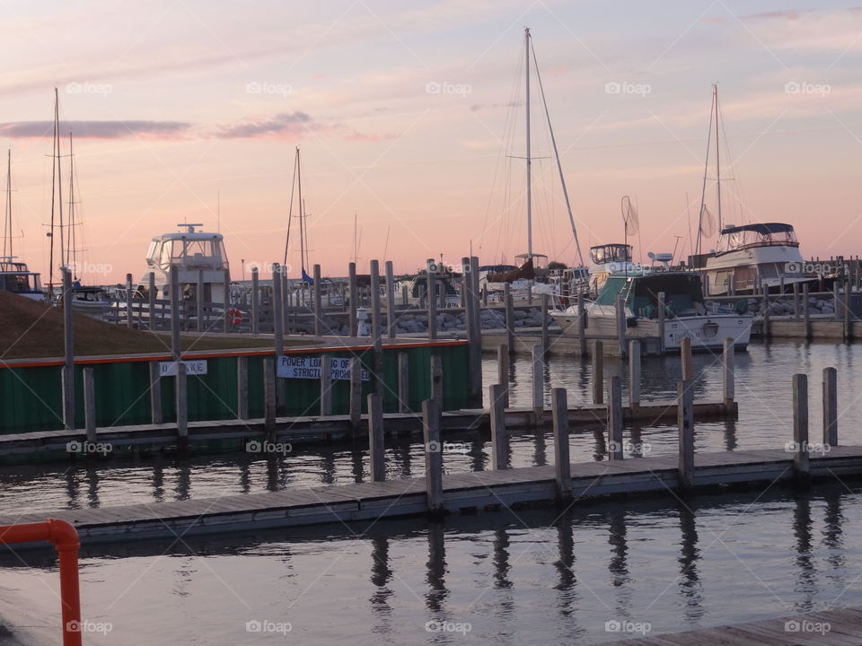 Harbor at Sunset. Boats in the harbor on Lake Huron, pulling in to dock before the sun goes down. 