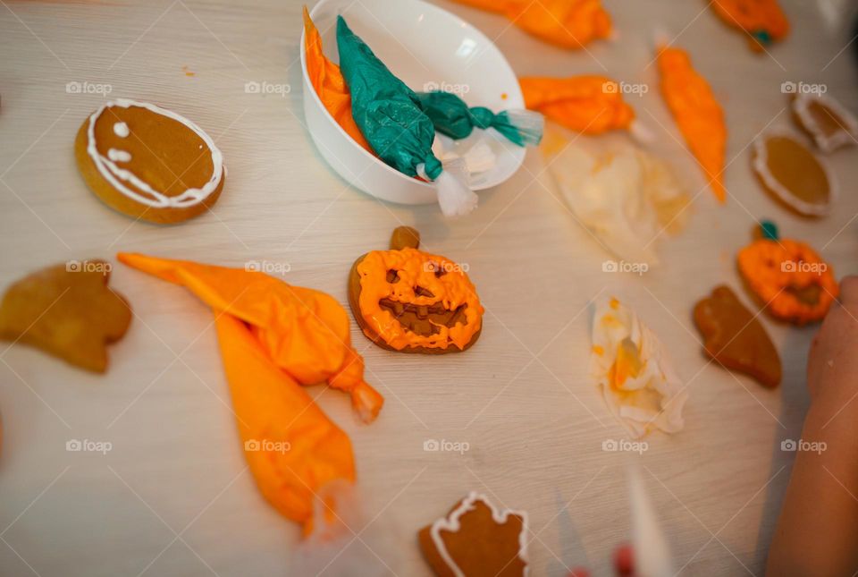 seven year old boy decorating handmade cookies for Halloween