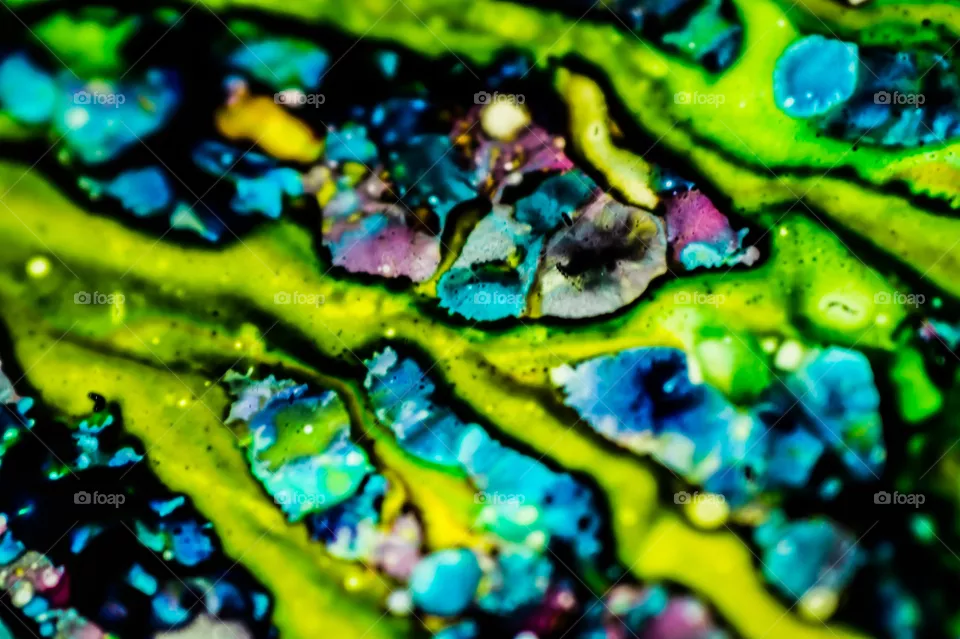 The ink to refill the printer cartridge was spilled onto the white washbasin and the paints blended into abstract drips and patterns