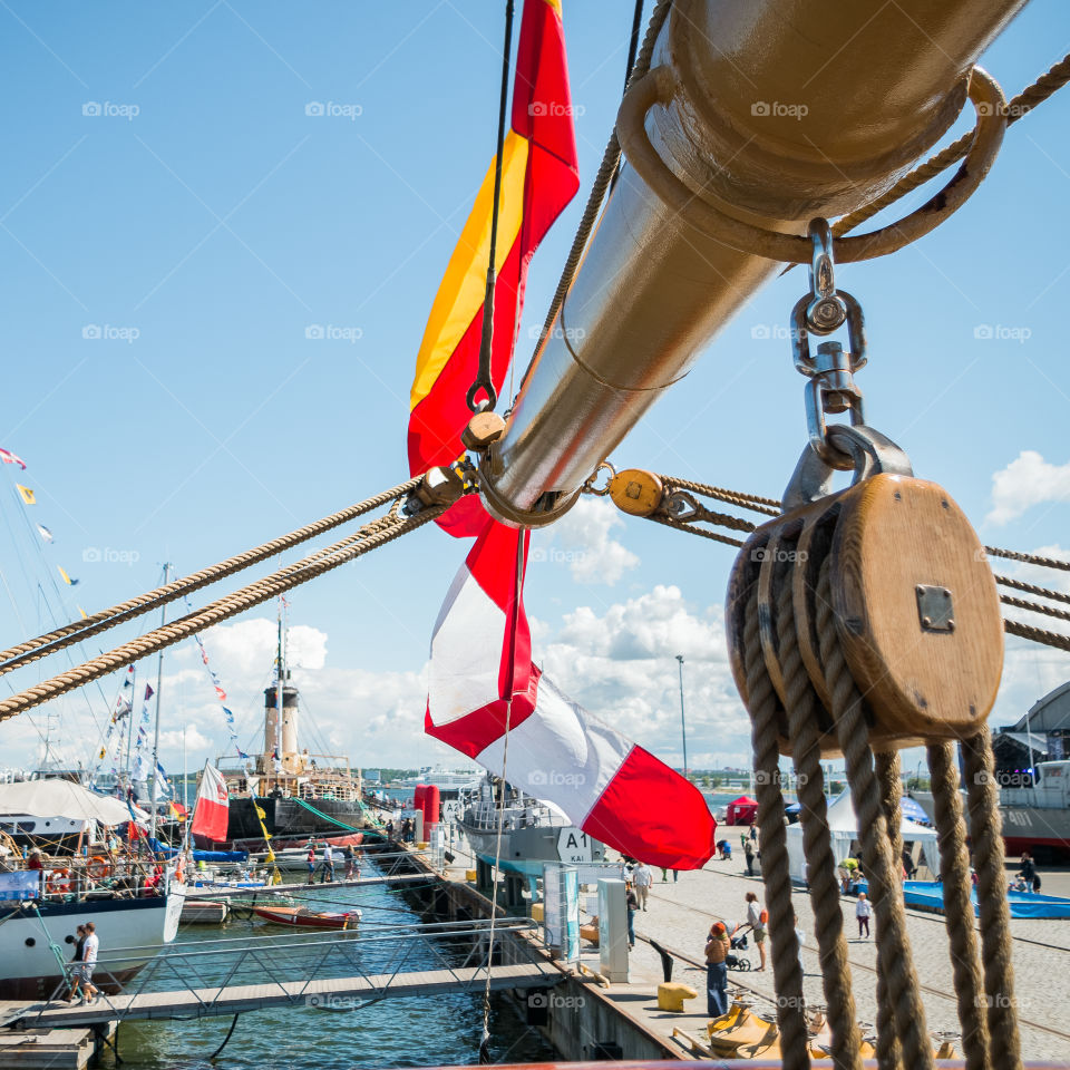 Colourful flags fluttering on the rigging of tall sailing ship in a Seaplane Harbour.