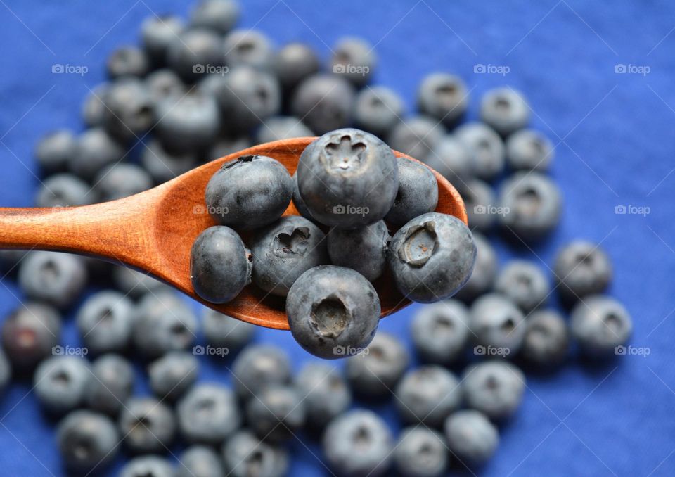 blueberry in wooden spoon close up, cooking