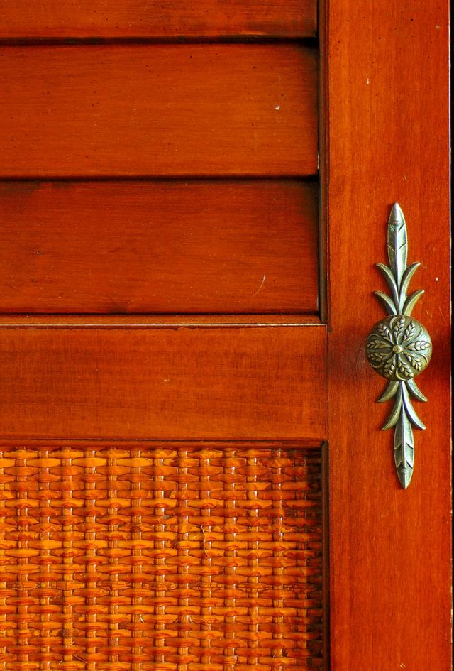 Random photo of a unique door handle on a TV cabinet.