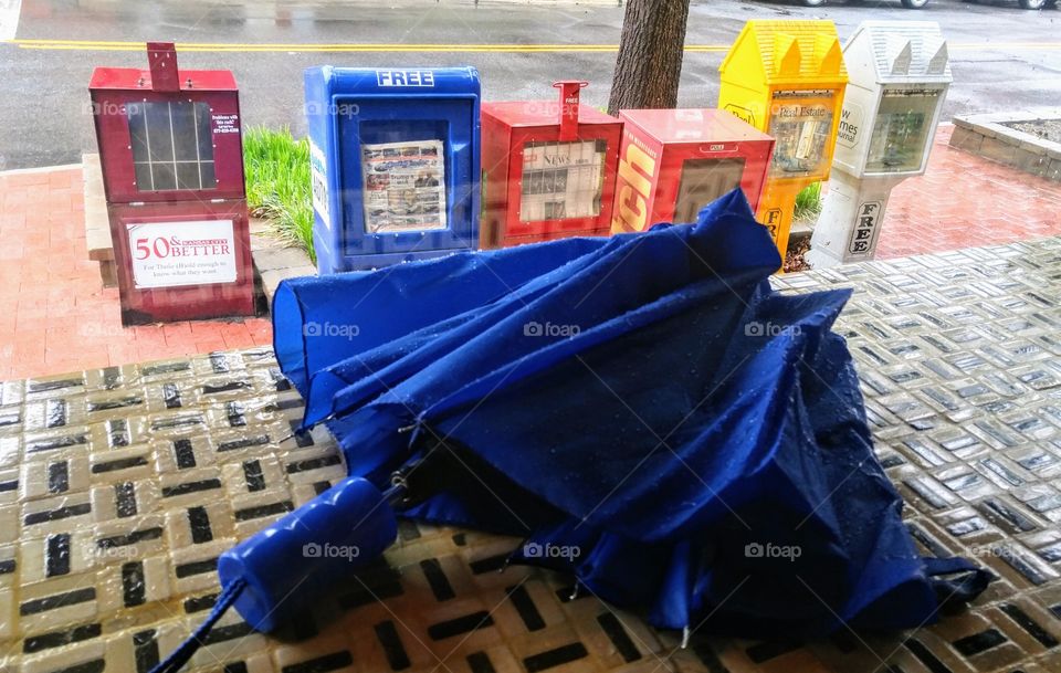 blue umbrella on wet counter