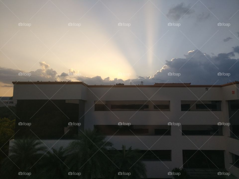 Rare view of the sun rays .. from behind the clouds on a beautiful evening.. Pictured clicked from my office..