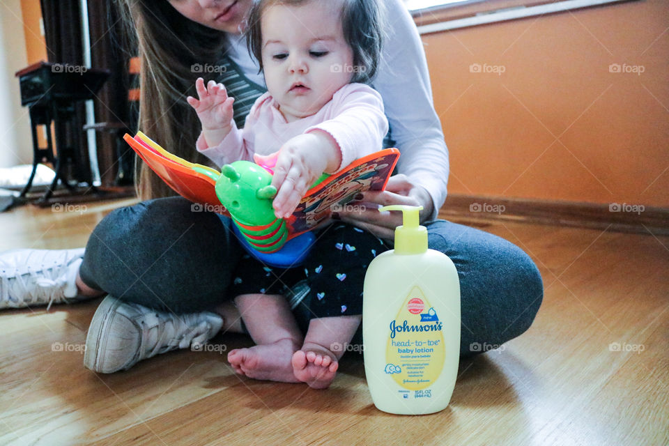 Johnson’s Baby Care- woman and baby reading a book.