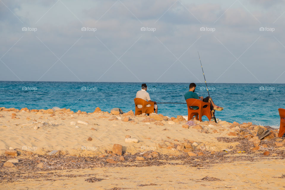 People fishing by the beach