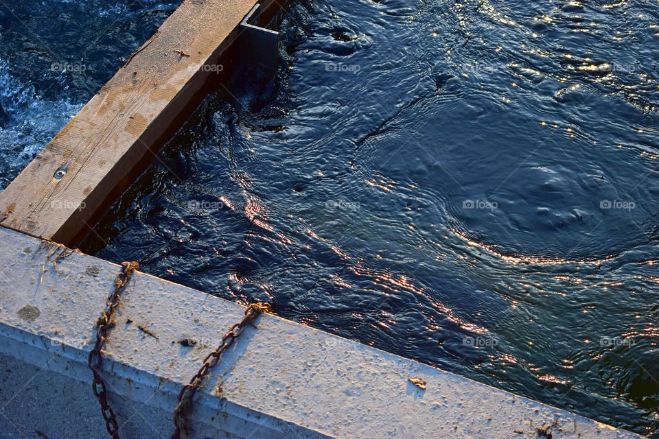 Sunset reflections in water of the river dividing Austrian town Steyr