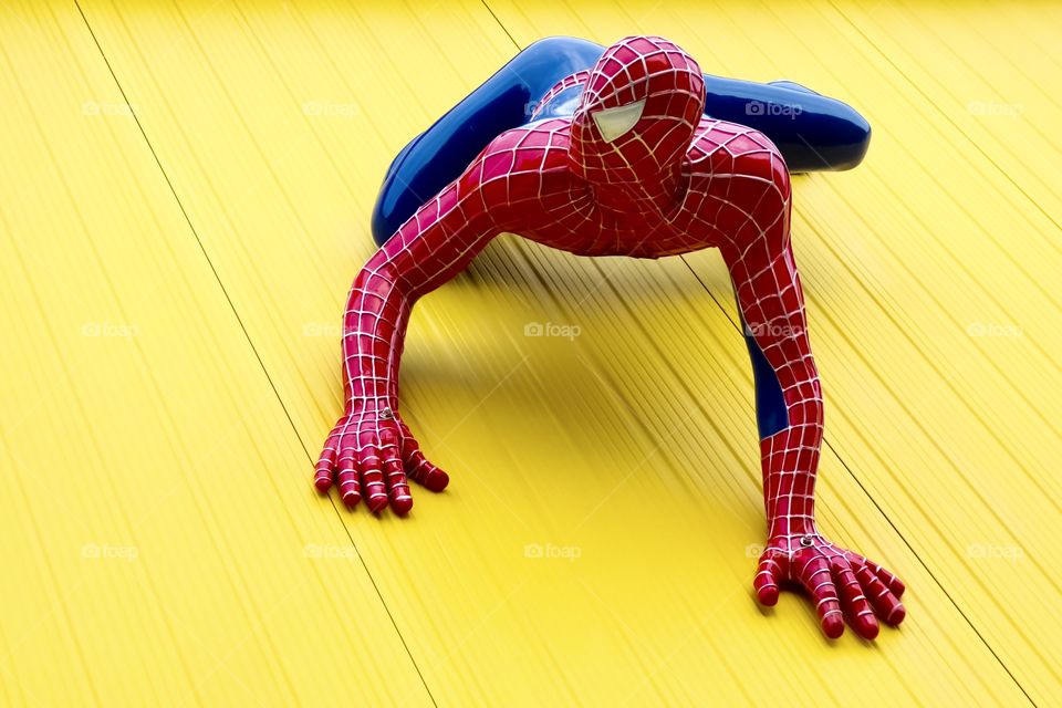 Spiderman on yellow wall