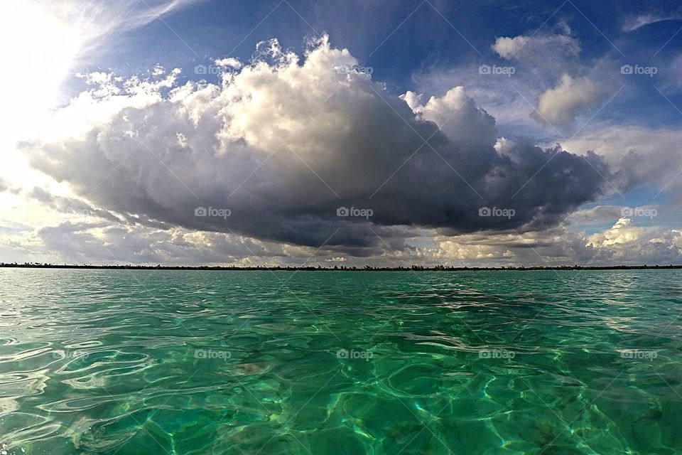 big Grey cloud over green mexican sea
