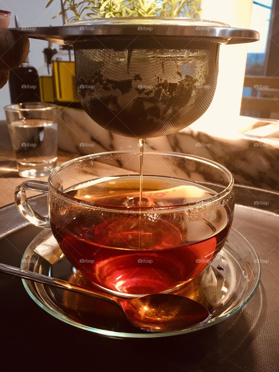 Tea being filtered inside a transparent round cup, hot drink, hot beverage, coffee and tea, tea time 