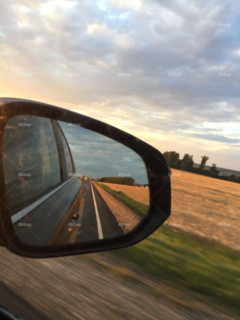reflection in the mirror of a moving car