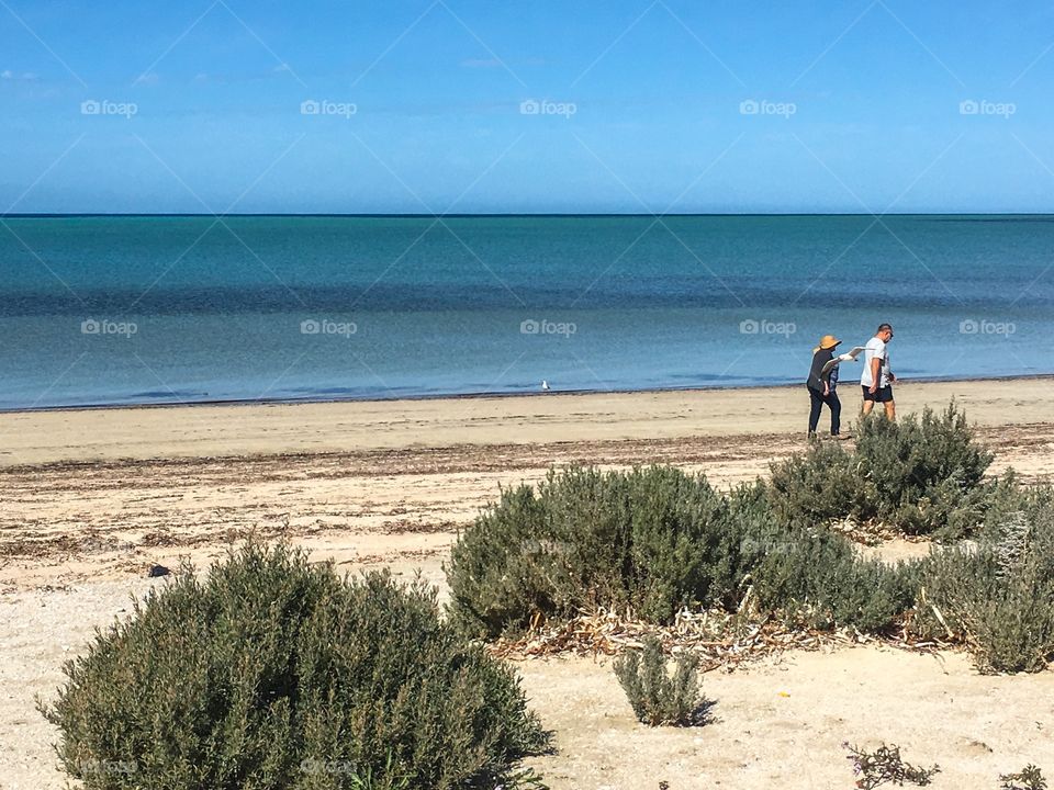 Senior couple walking along beach south Australia 