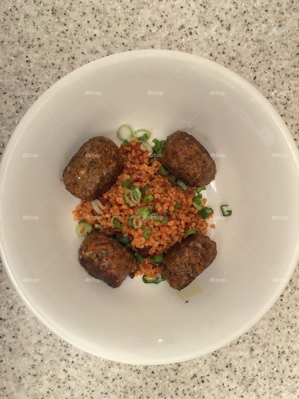 Minted lamb koftes with harissa spiced bulgar wheat and spring onions