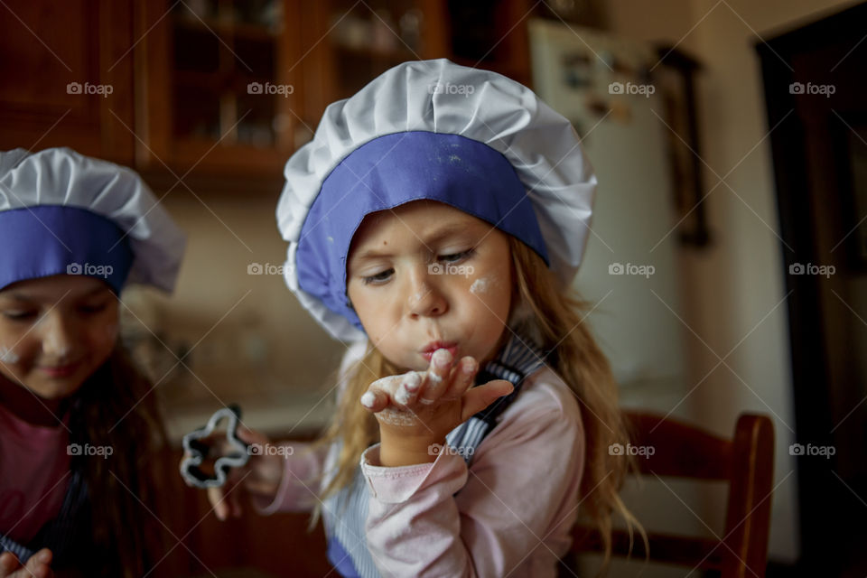 Little sisters cooking the biscuits 