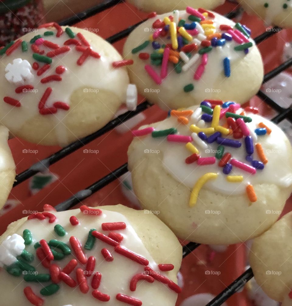 Italian ricotta cheese cookies iced with colorful jimmies Christmas cookies