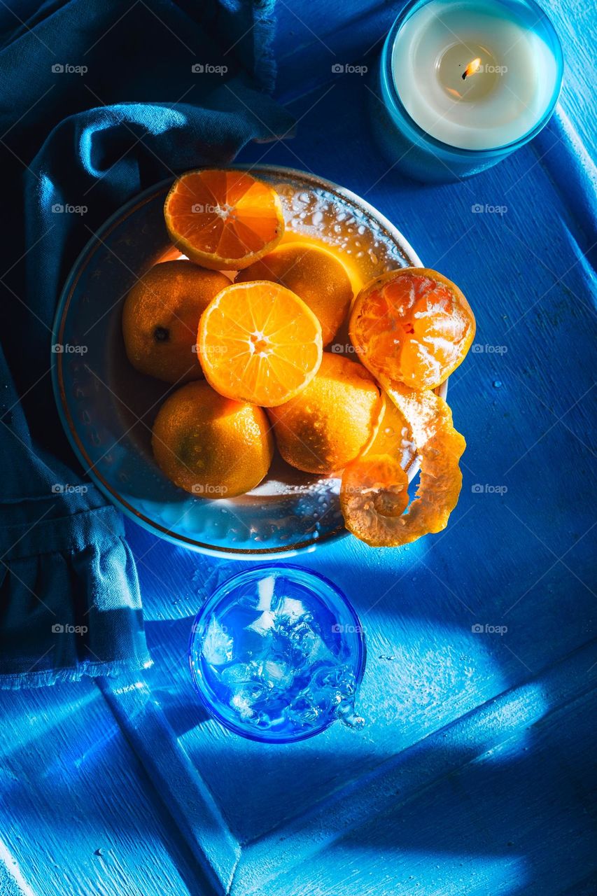 Fresh and juicy tangerines on blue plates