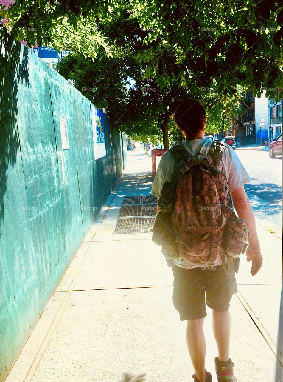 My partner in life, Timothy carrying his rucksack walking in front of me on Fulton Street in Fort Greene, Bklyn on a beautiful August afternoon in 2020. Hypnotic Productions 