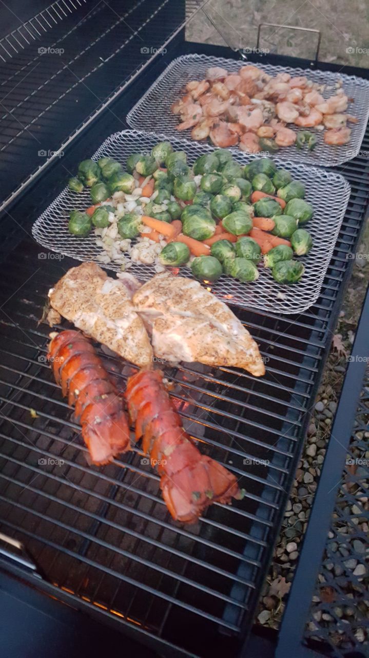 Chicken and lobster on grill
