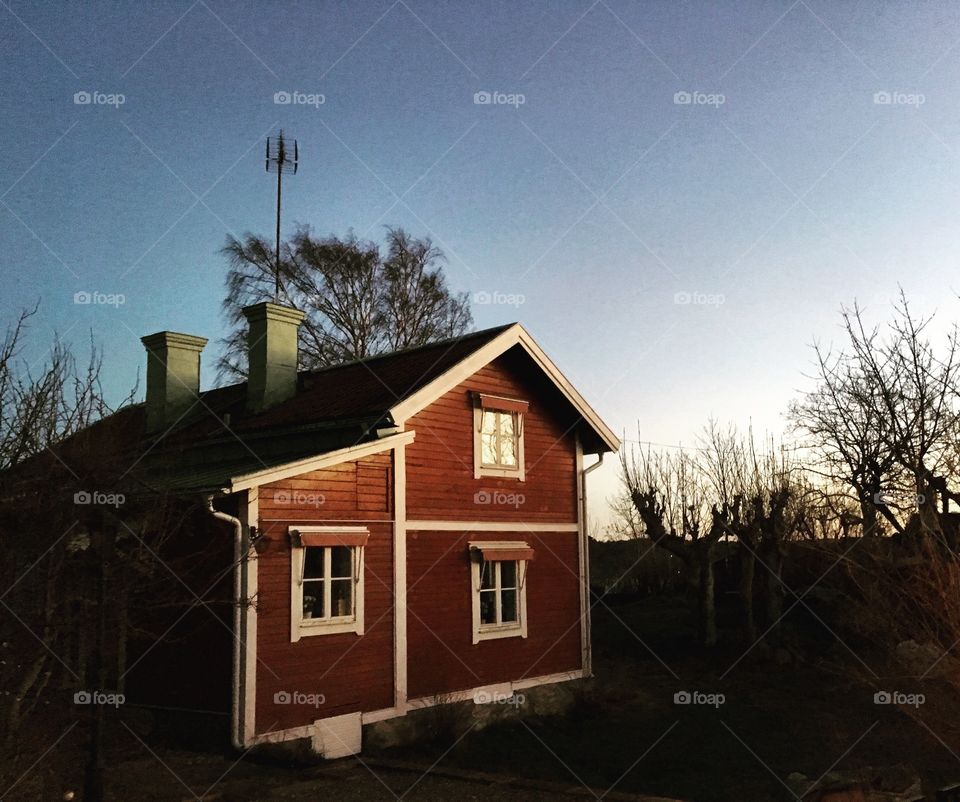 Red cottage in sunset, archipelago 