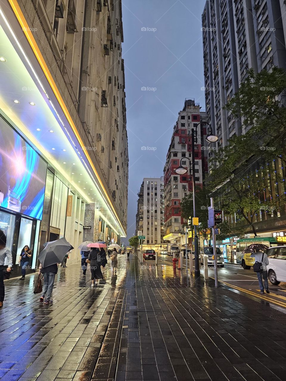 Night view of the city, street, building, people walk with umbrella on Jong Kong Causeway Bay Paterson Street