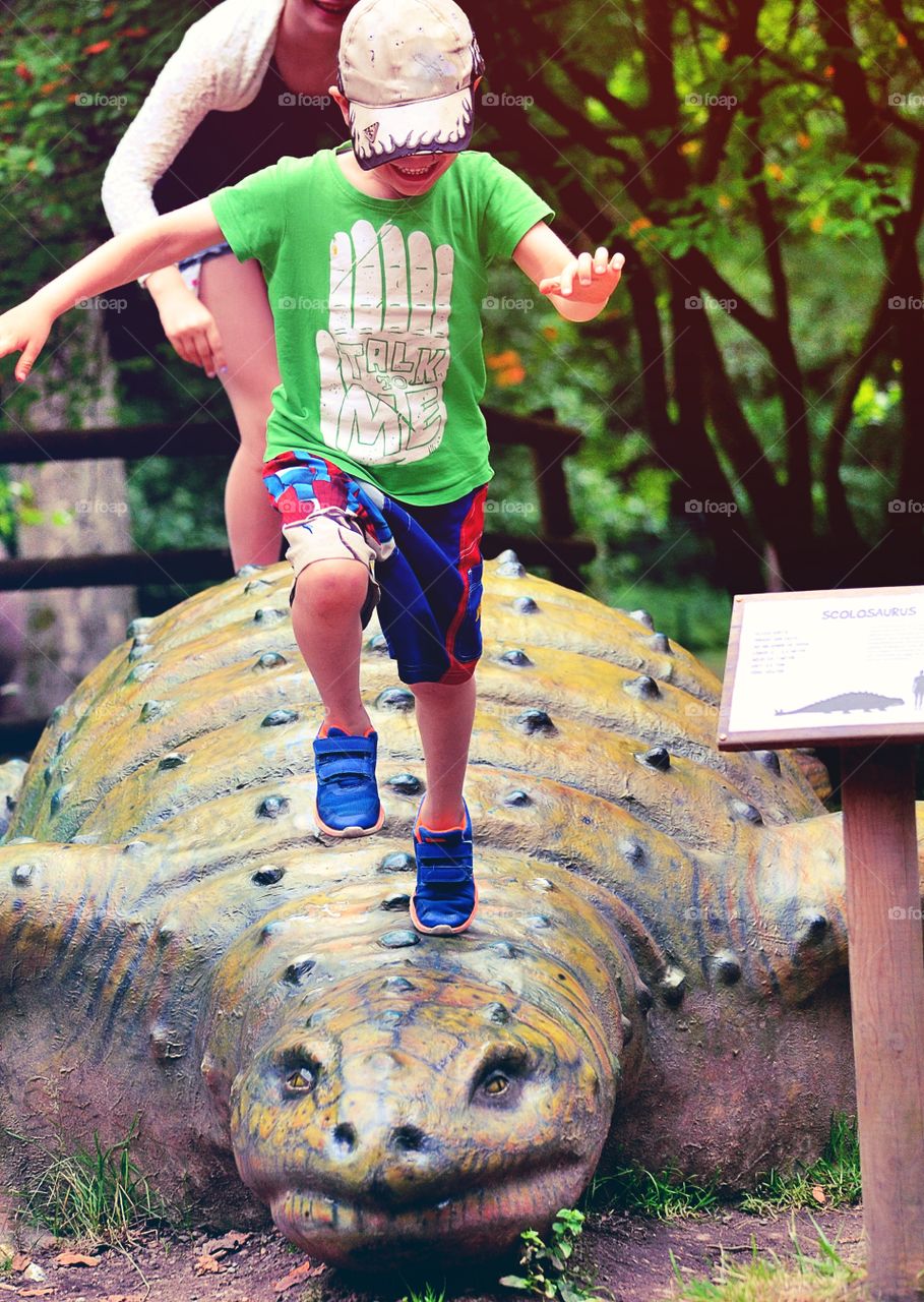 Jumping. Siblings playing in the park