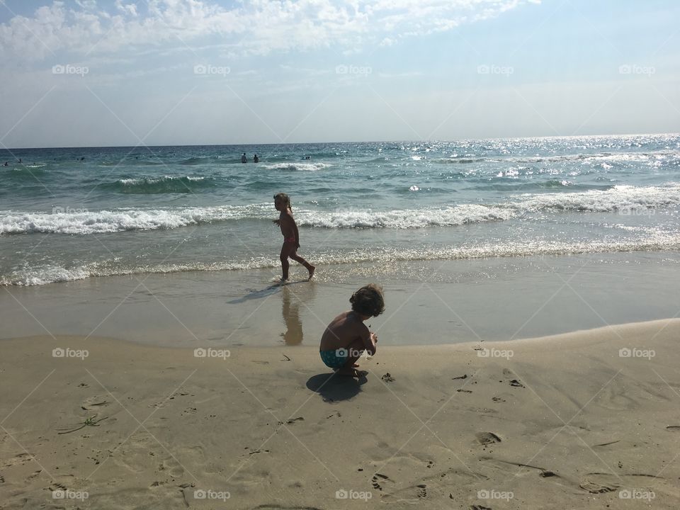 Two children playing on beach