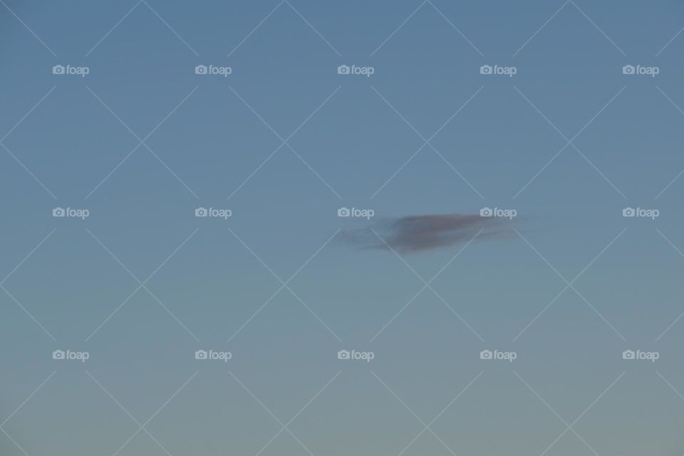 Blue sky and one cloud in the sunrise