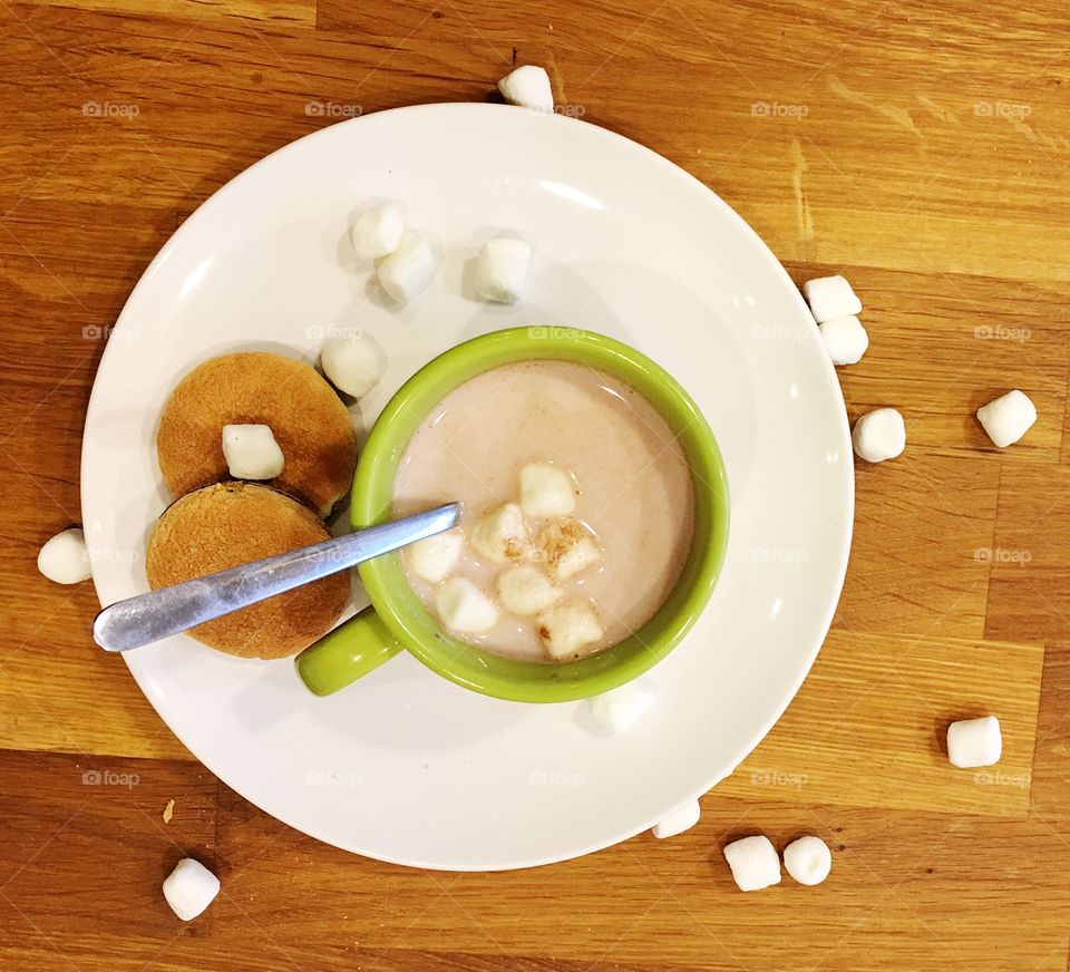 High angle view of coffee with marshmallow and chocolate cookie