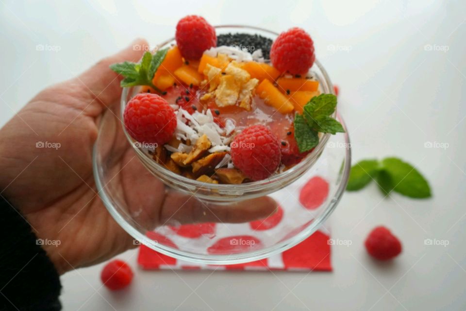 Smoothie fresh fruits bowl - peach, raspberry,  almonds,  strawberries,  coconut,  honey,  seeds and mints