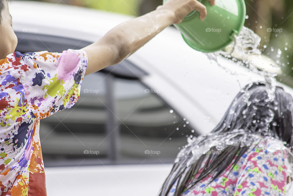 Hand holding Plastic bucket play Songkran festival or Thai new year in Thailand.