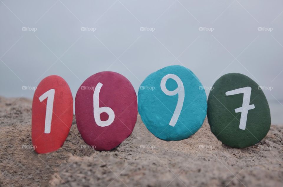 year 1697, MDCXCVII, on colourful stones