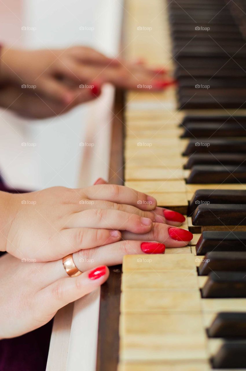 mother teach a son to playing piano