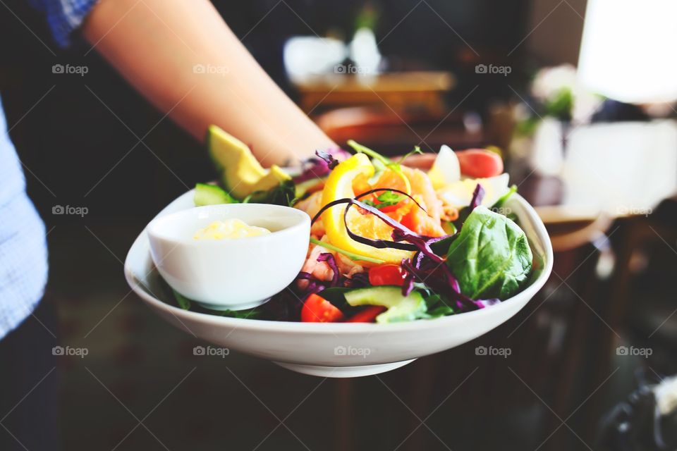 Person holding salad in a bowl