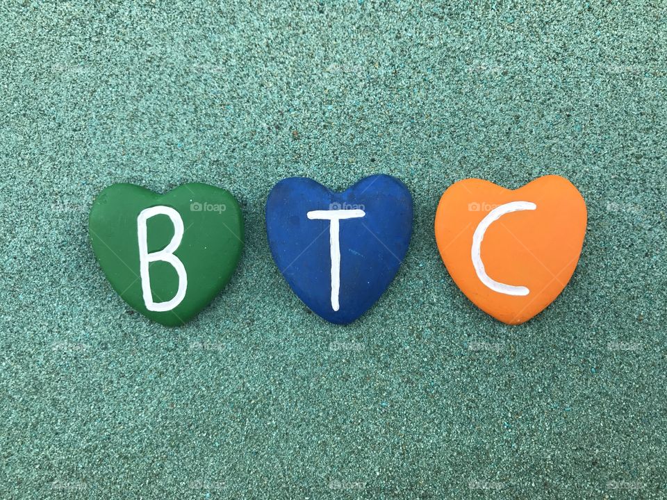 
BTC, Bitcoin, worldwide cryptocurrency and digital payment system with colored heart stones