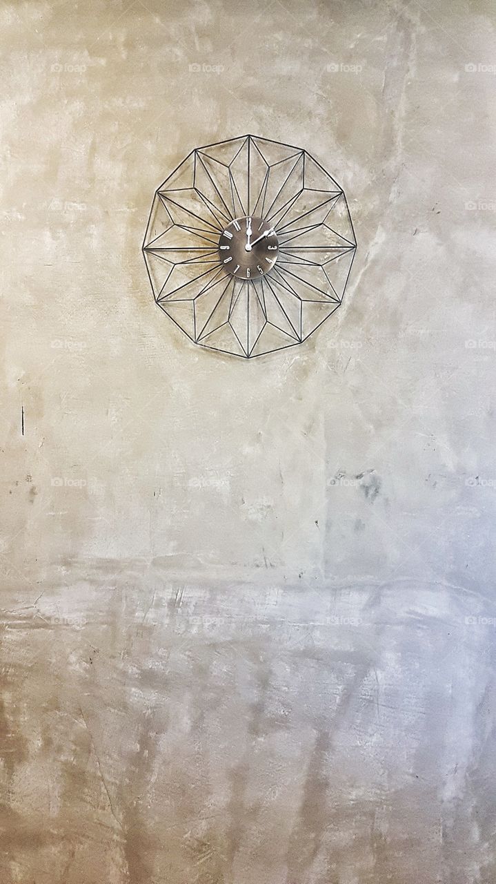 modern minimalist clock on concrete wall