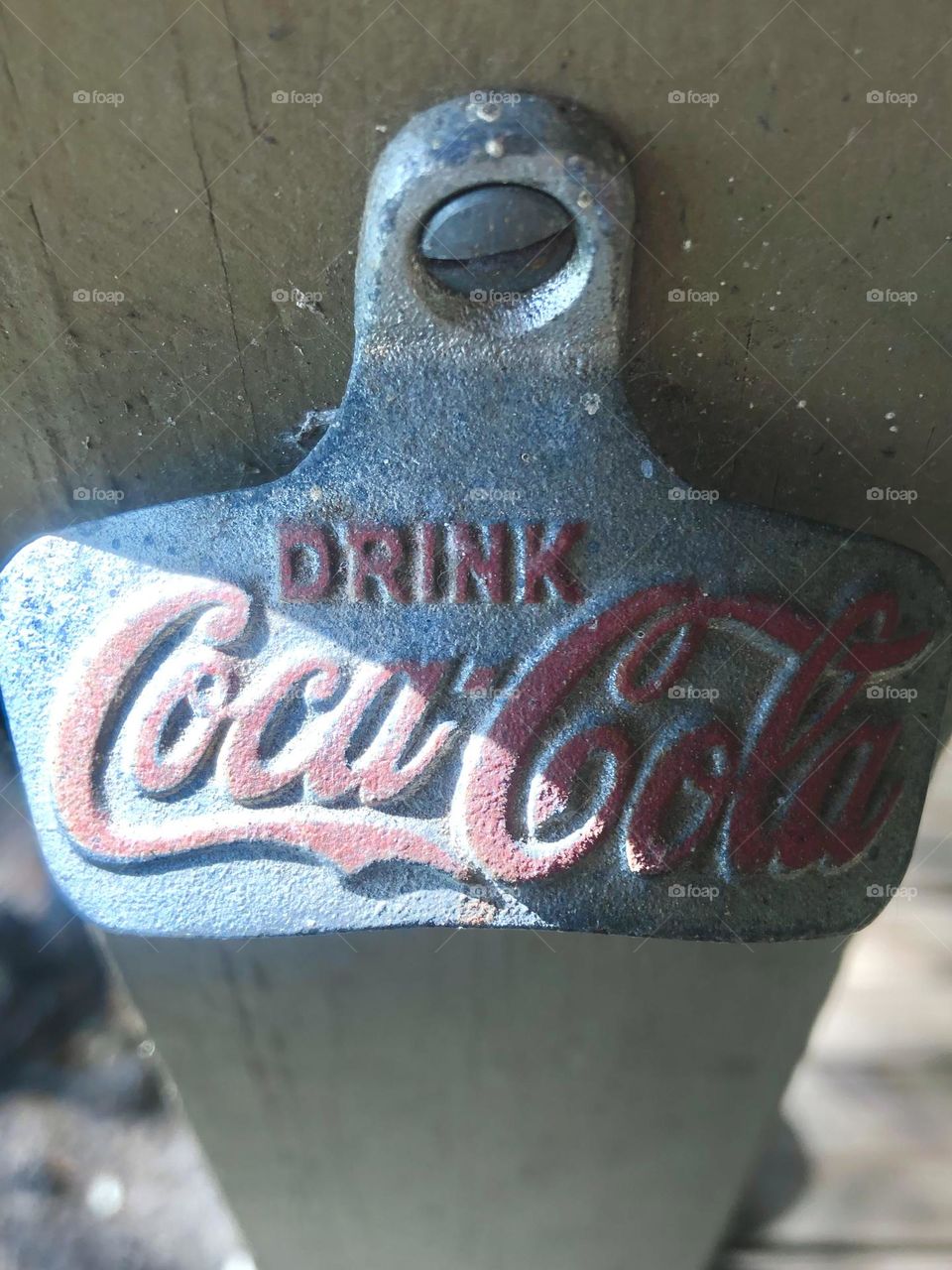 A very old Coca-Cola bottle opener that’s actually on our front porch here on the ranch. Been there forever!