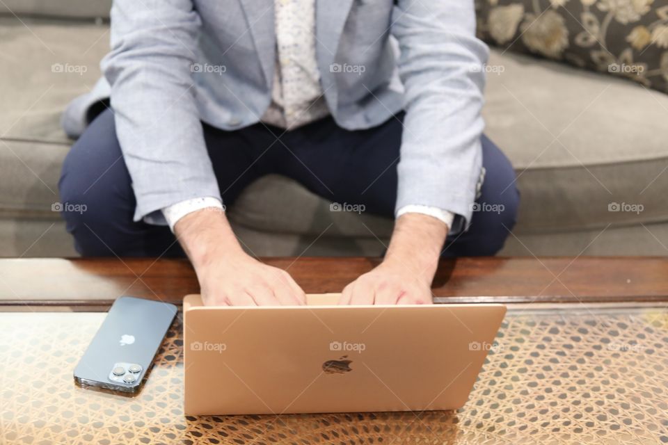 Working Man Working From Home MacBook Air and iPhone 12 Pro Max