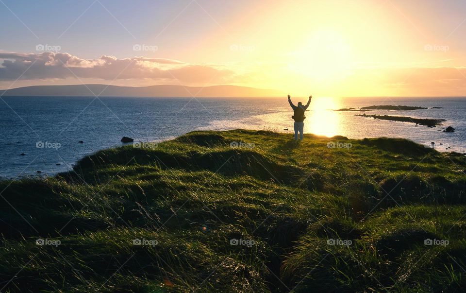 Man on the edge of the cliff at Cloosh, Galway, Ireland