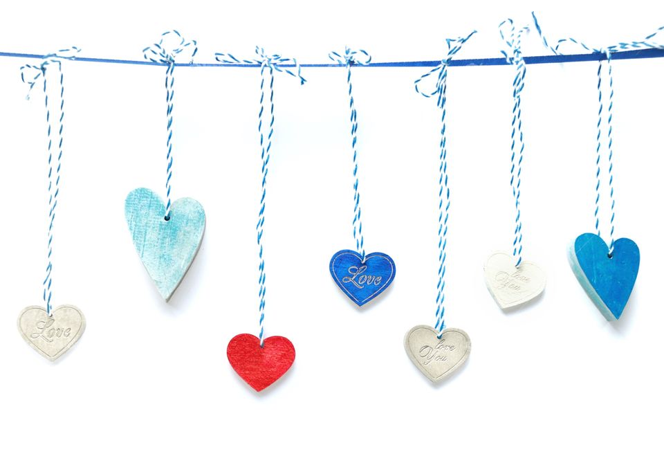 Colorful wooden hearts on white background 