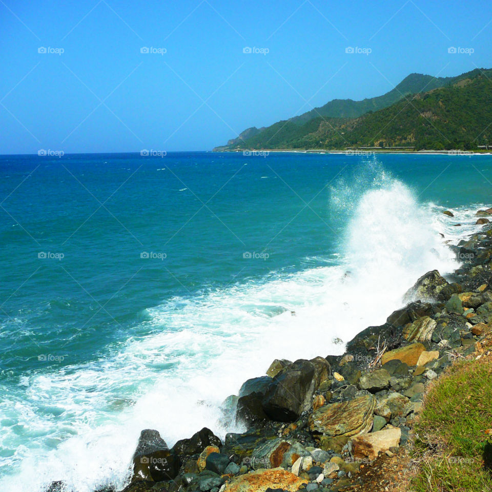 Powerful Waves from the Caribbean Sea crashing  against the protective rocky shoreline! 
This landscape photo was taken in Santiago de Cuba!