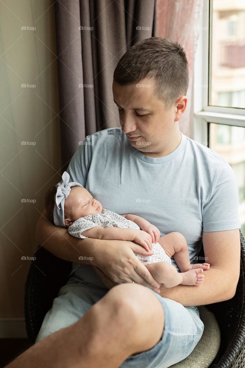 Young father with newborn baby