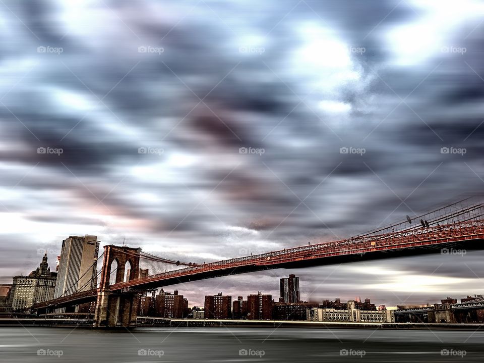 Brooklyn Bridge under turbulent skies