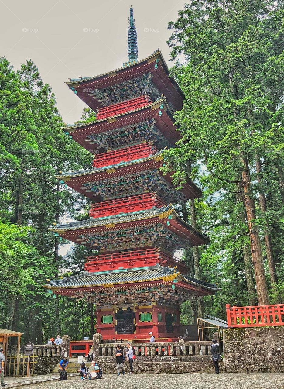 A red oriental pagoda temple in the Japanese bamboo forest.